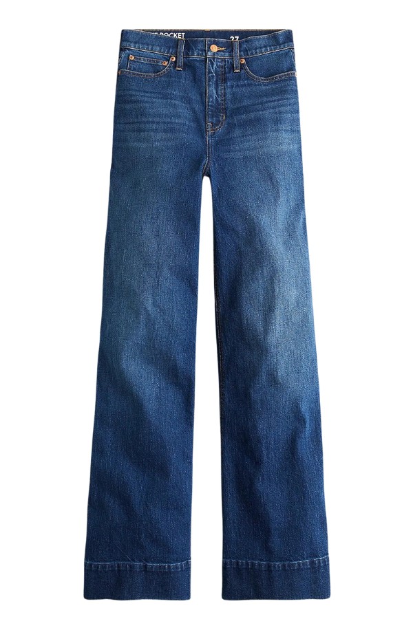 A pair of women's blue jeans for are pictured against a white background. The style is slightly wide at the bottom.