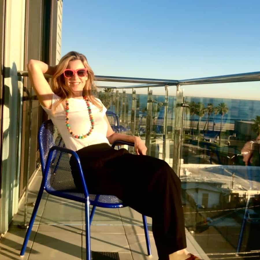 Susan Heinrich sits on a balcony at the Hotel Erwin Venice, California