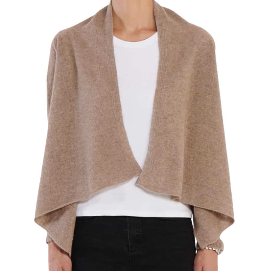 A camel colored cashmere poncho wrap over a t-shirt. Ideal travel essential or capsule wardrobe item.