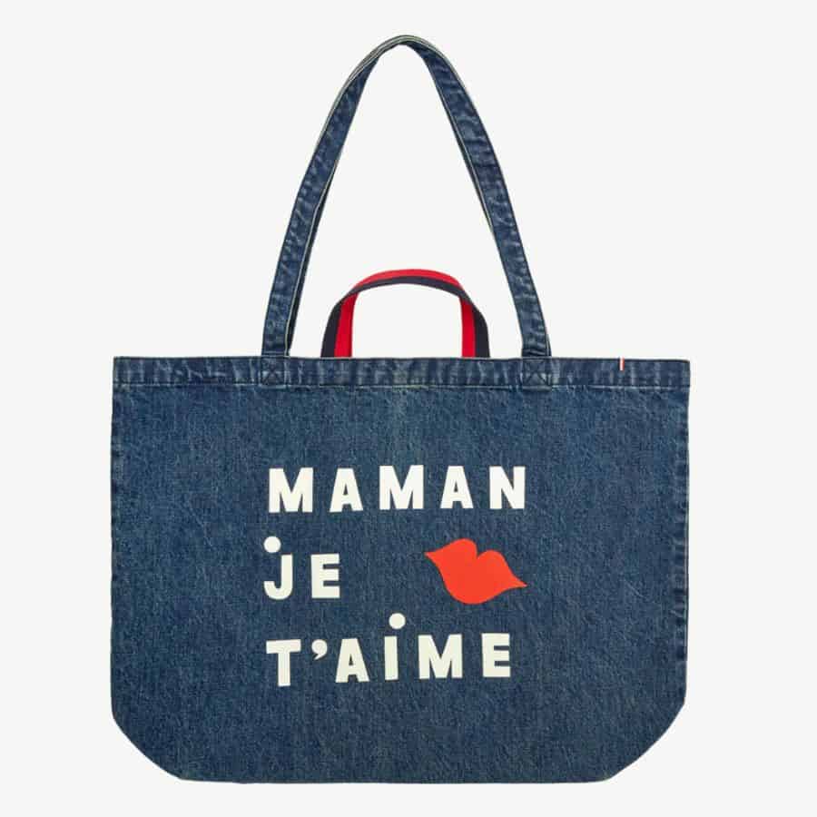 A blue denim tote bag says "Maman Je T'Aime" in white letter and a decoration of red lips is also visible.