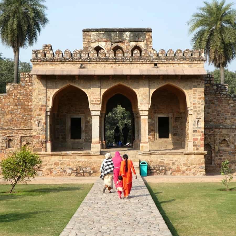 Indian women walk within the Humayun's Tomb Complex in Delhi, India