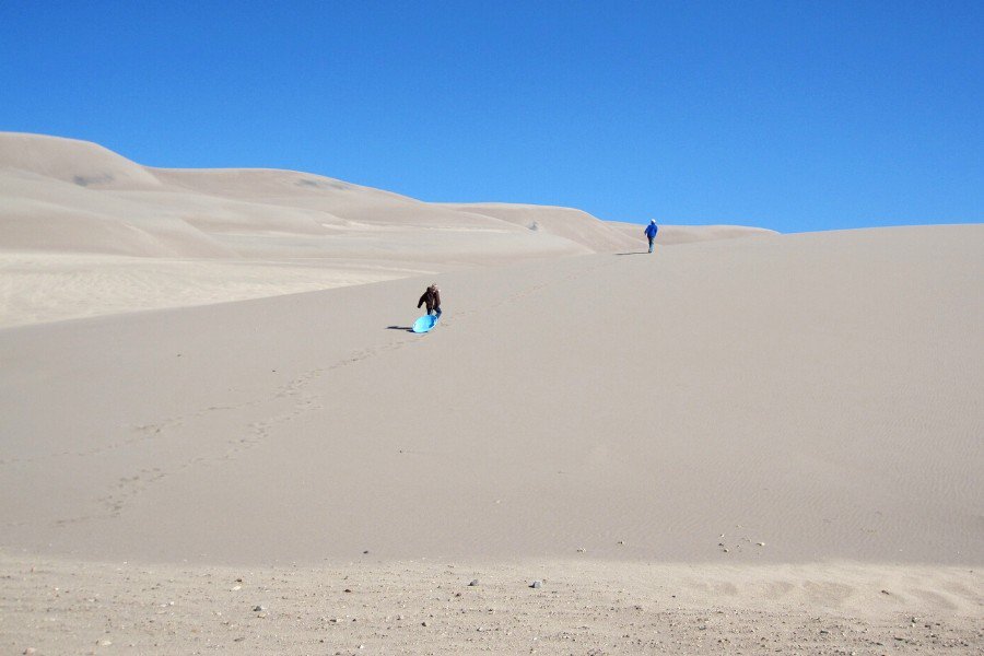 kids climbing the great sand dunes