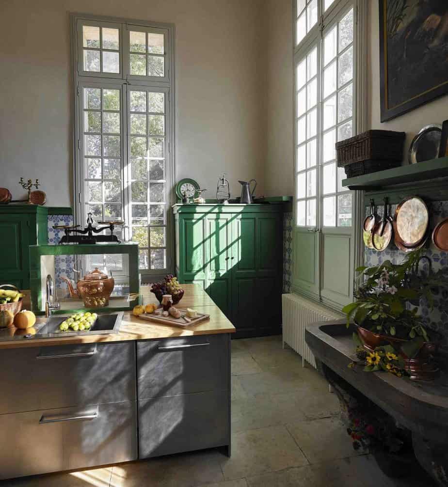 A French kitchen us pictured with traditional furniture and food being prepared. Photo ©️ Brice Pelleschi.
