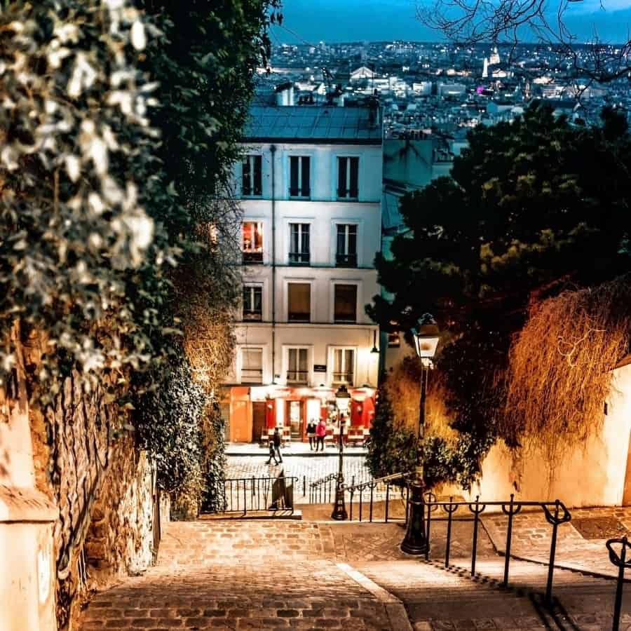 Stairs lead up to the Monmartre district of Paris at night