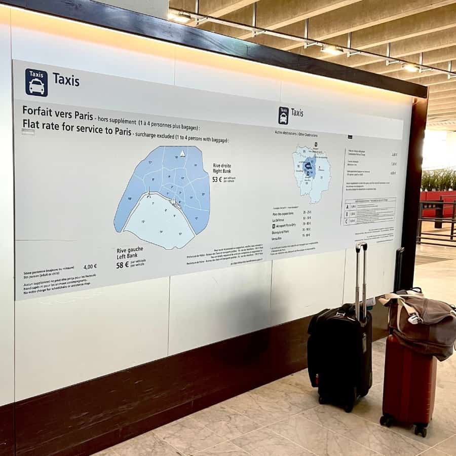 A sign at the Charles de Gaulle airport in Paris displays a map and prices for taxis to Paris