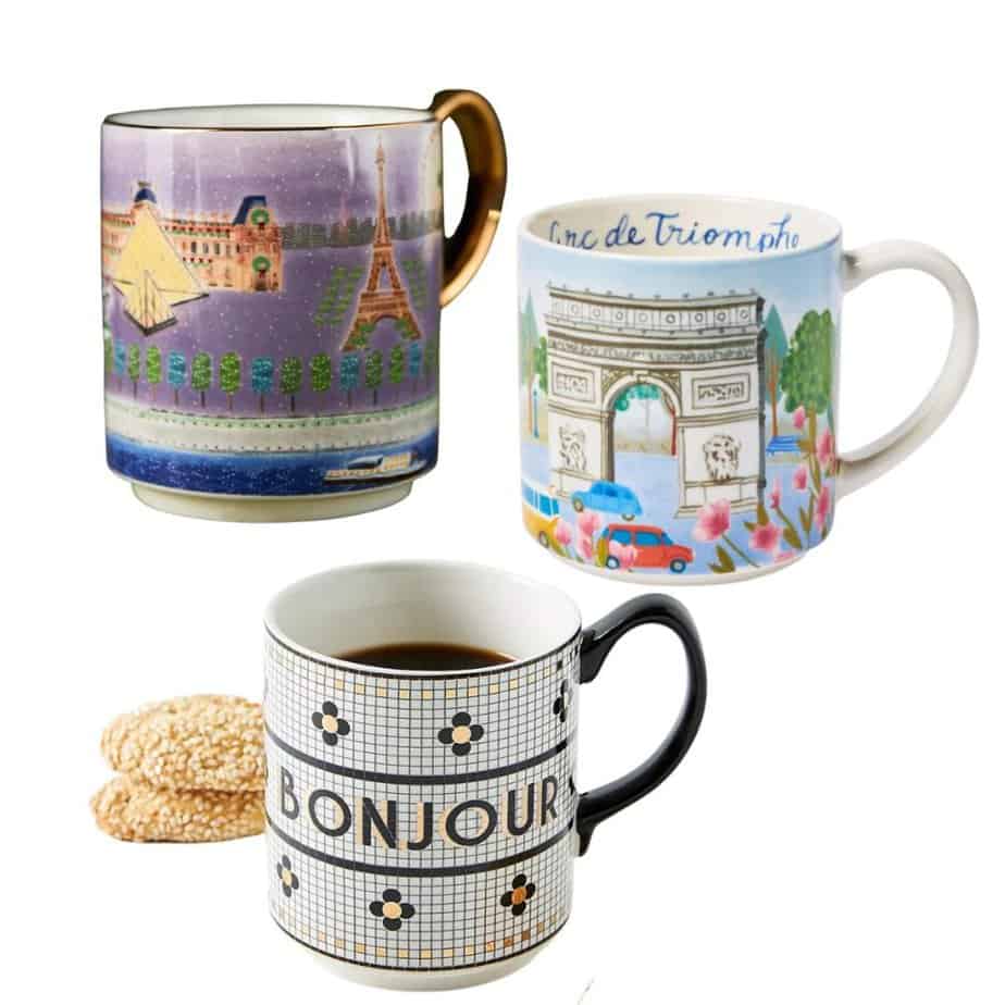 Three French-themed mugs are shown. One says bonjour and has a retro French tile design, one shows the Eiffel Tower and the other features the Paris Arc de Triomphe.