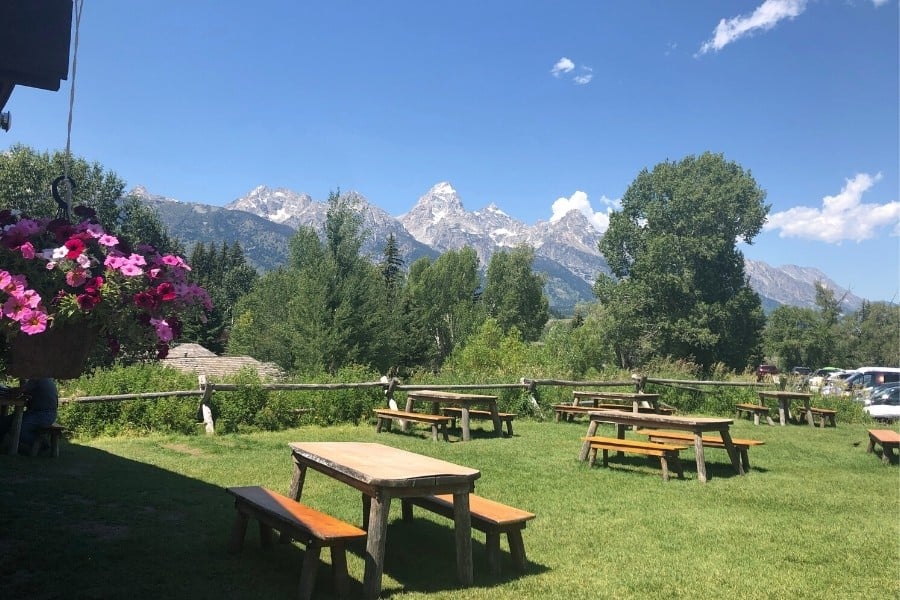 Picnic tables offer a Teton mountain view at the Chuckwagon restaurant in Dornans