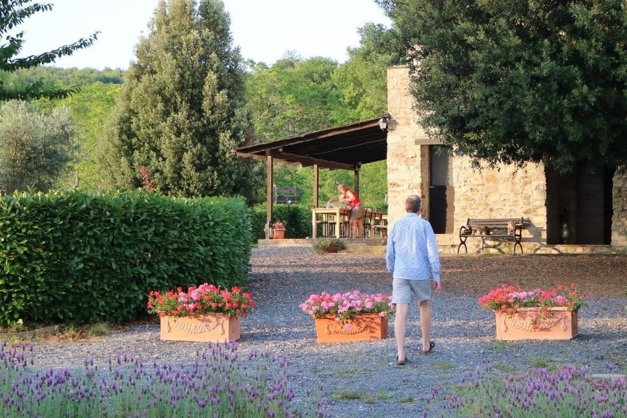 Daniela prepares the dining table for dinner al fresco at Antica Olivaia, Umbria Agriturismo