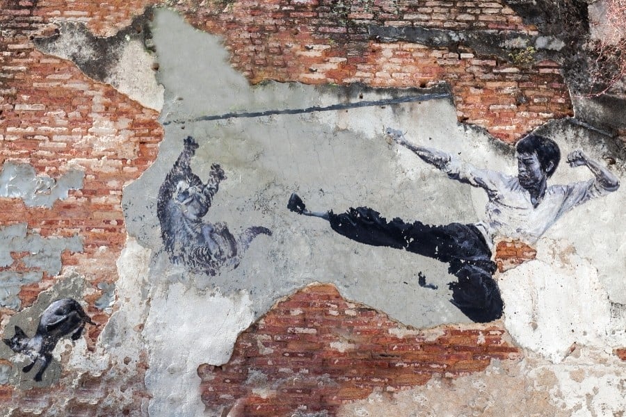 A mural of Bruce Lee and a cat in Penang