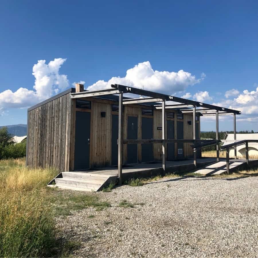 A building at Under Canvas Yellowstone has showers and toilets for guests staying in the safari tents