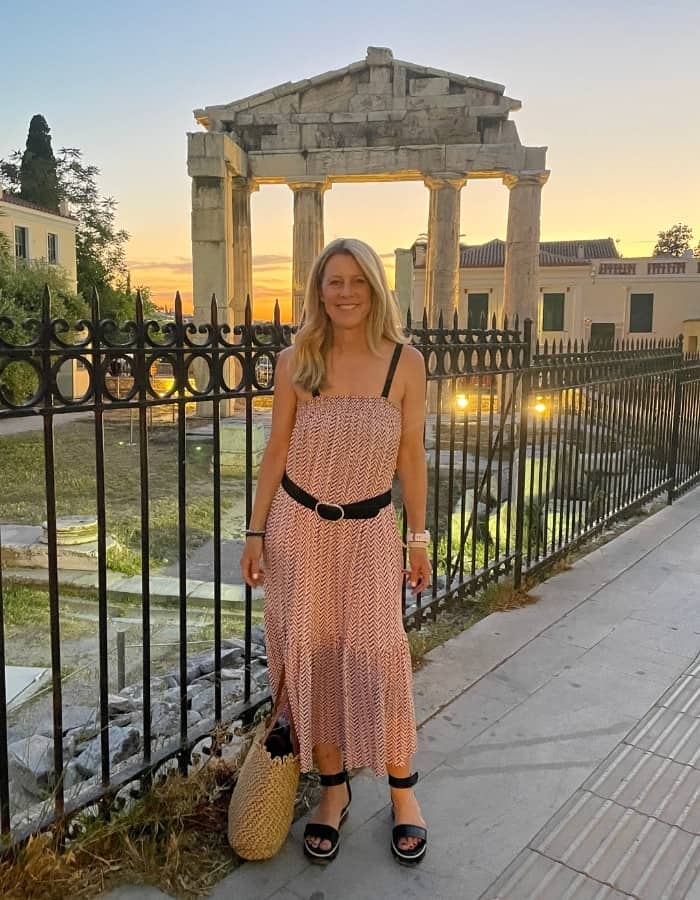 Susan Heinrich stands in front of the Gate of Athena Archegetis on a walking tour of Athens, Greece