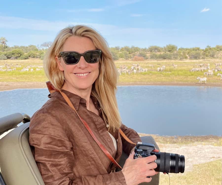 Susan Heinrich in a safari jeep holding a camera. She's in Botswana in the Magkadikgadi Pans National Park.