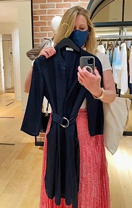 Susan Heinrich holds a navy dress by French clothing brand Claudie Pierlot