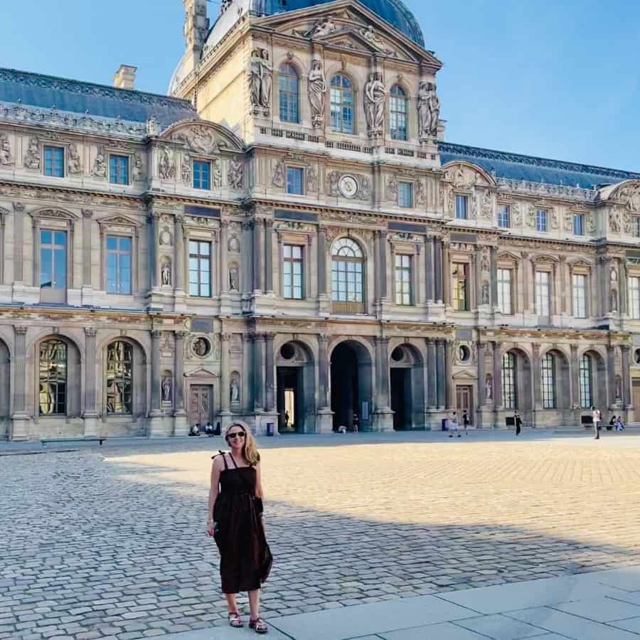 Susan Heinrich stands in front of the Louvre in Paris