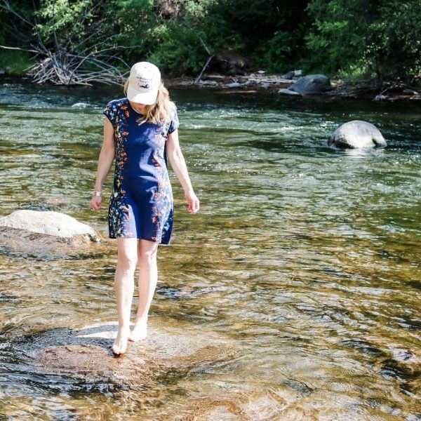 Susan Heinrich stands on a rock in a river in Beaver Creek Colorado