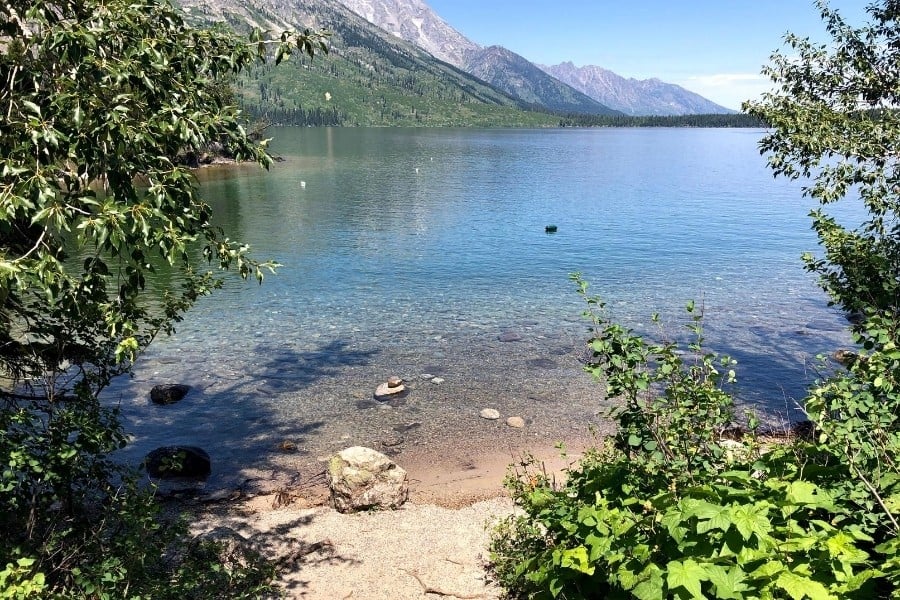 A small and sandy swim beach at Jenny Lake in Grand Teton National Park