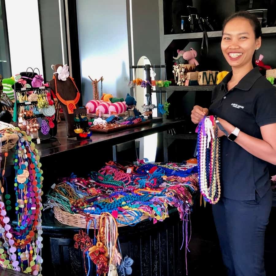 A woman holds a necklace at a gift shop at the Shinta Mani hotel in Siem Reap Cambodia