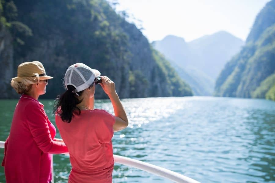 women on a group trip enjoy a scenic view